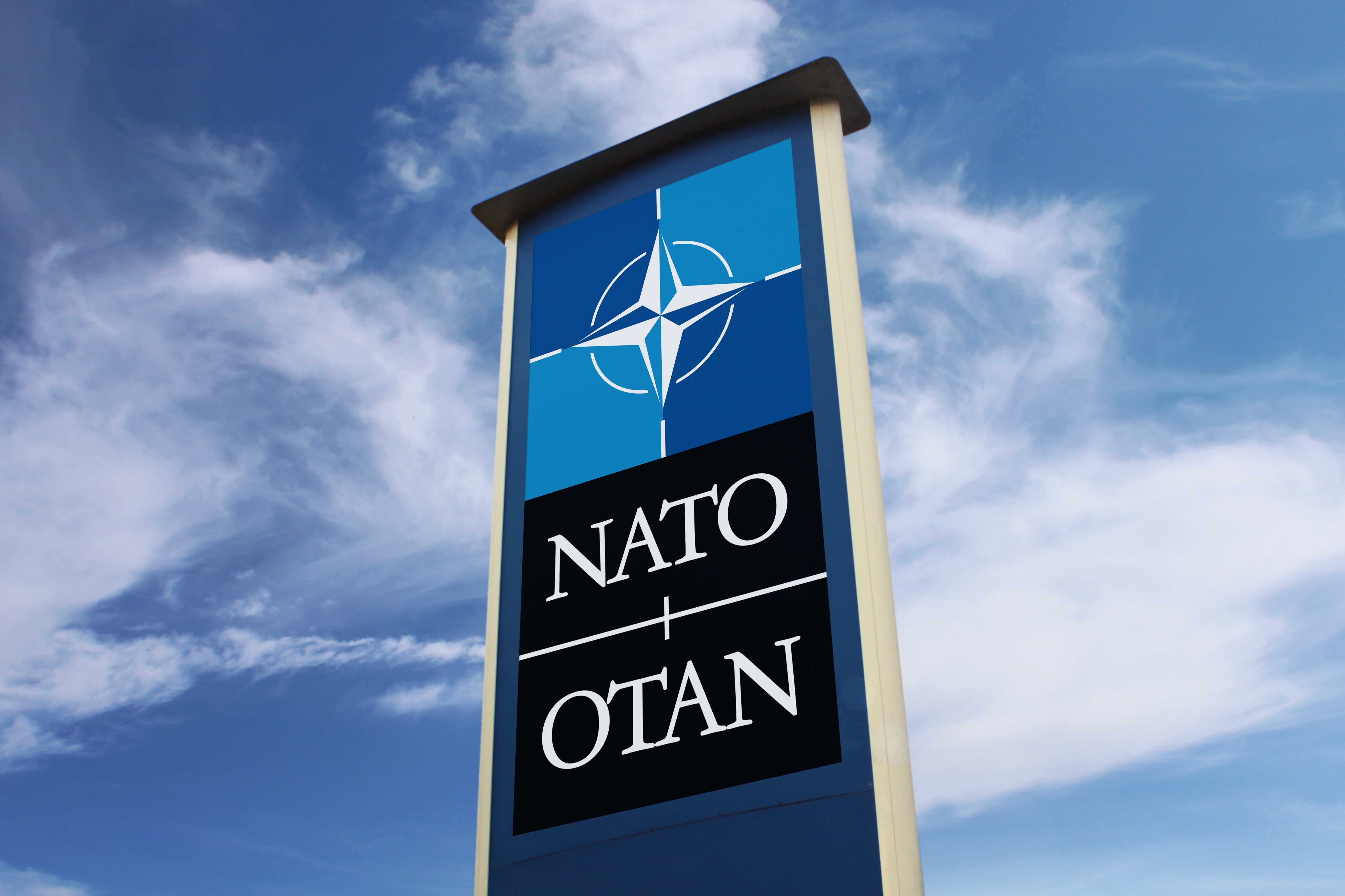 Nato sign against blue sky